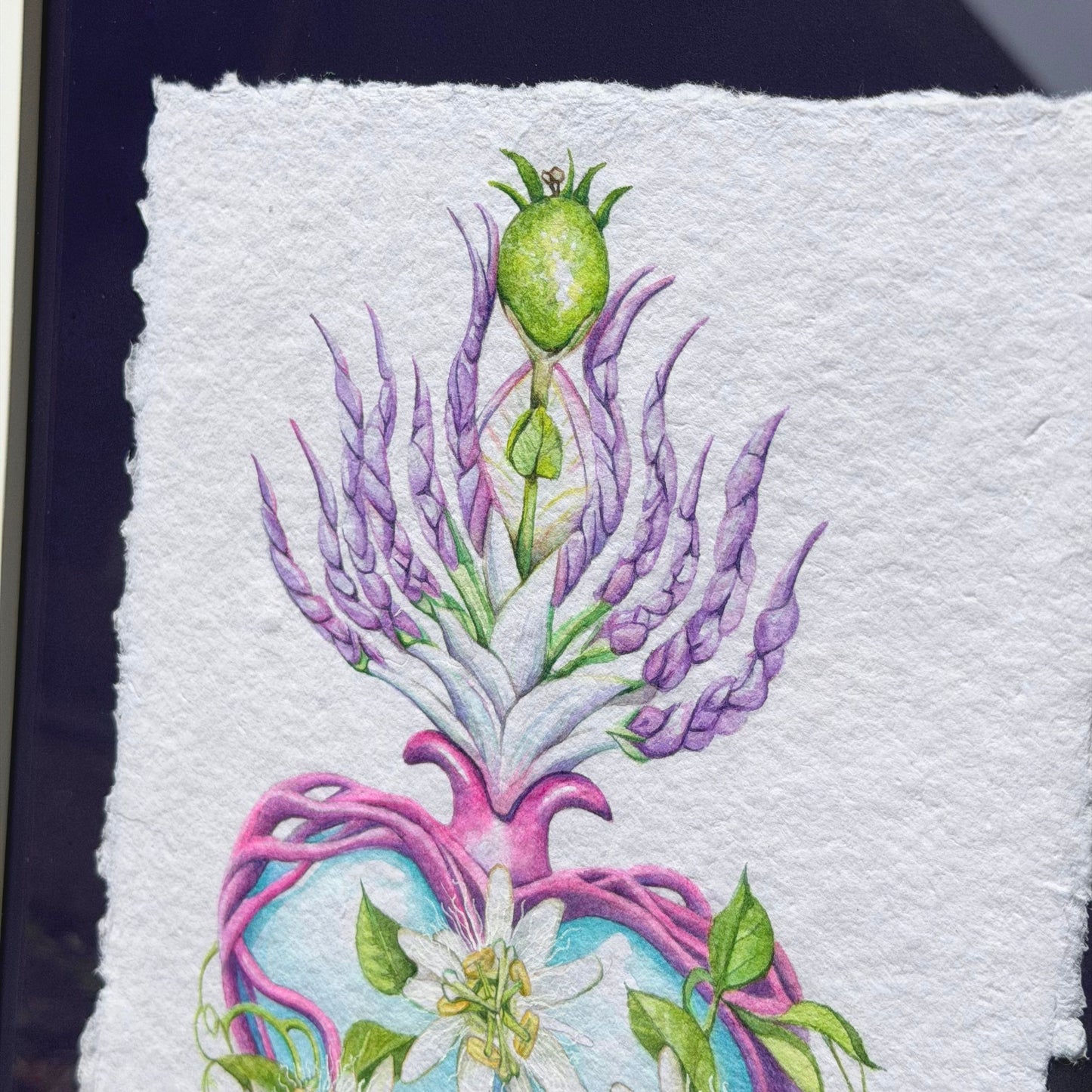 Colorful embroidered design on fabric with floral and abstract Framed original watercolor painting artwork with botanical sacred heart design featuring Lilikoi passion flowers and leaves on a white background of handmade paper, signed and embossed by artist Liliane Avalos