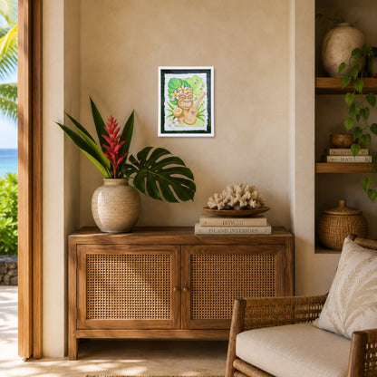 Living room with wooden cabinet, decorative items, and a painting on the wall. Framed artwork of a tiki , ukulele, and tropical flowers with leaves on a green background. Aloha Mele, watercolor painting on handmade paper, by Liliane Avalos, Kauai Hawaii 2026. Framed artwork of a tiki, ukulele, and tropical leaves with flowers on a green background.