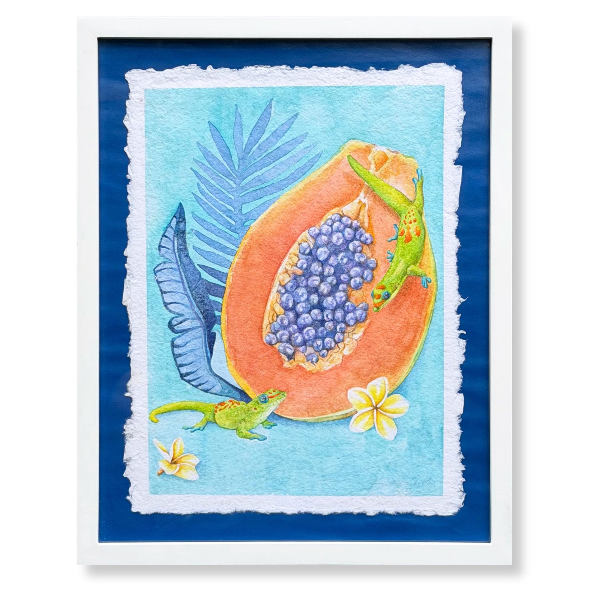 Framed artwork of a papaya with blue fruit and lizards on a blue background. Luxury Hawaiian home artwork of a Sunrise papaya with leaves on a wall above a table with decorative items. Framed artwork of tropical plumeria flower with palm leaves on a blue background. Good Morning Geckos, watercolor painting on handmade paper, by Liliane Avalos, Kauai Hawaii 2026. 