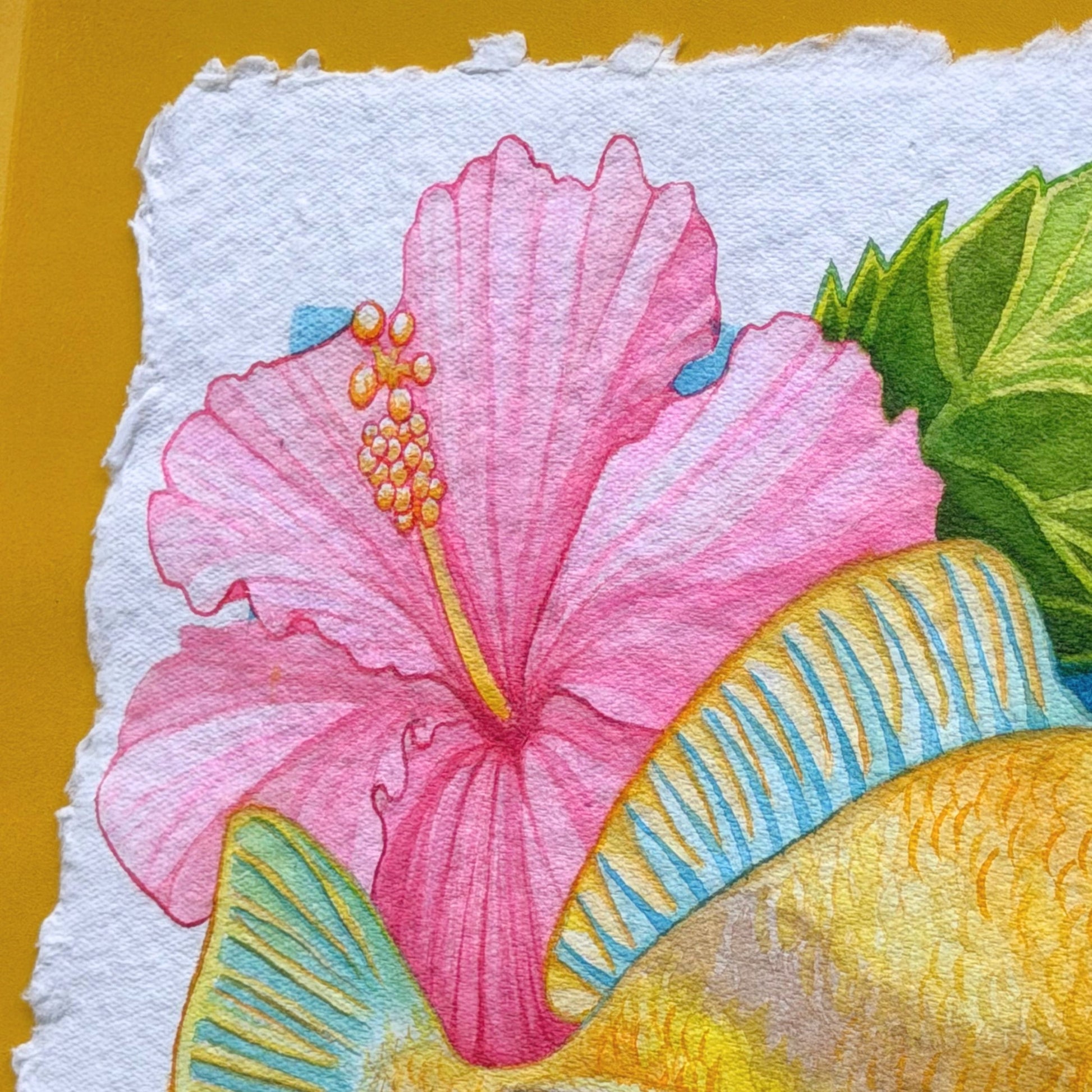 detail Colorful floral illustration on textured handmade paper with a yellow background Framed watercolor painting of Humuhumunukunukuapua'a artwork color ful yellow trigger fish and hibiscus botanical flowers on a yellow background, white frame Humu_Harmony_2026_Liliane_Avalos_watercolor_painting_framed_Kauai_Hawaii_lifestyle