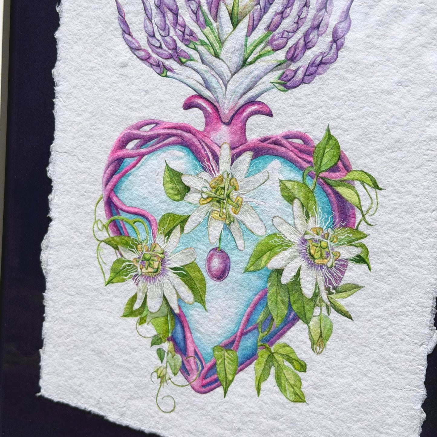 Heart-shaped design with flowers and leaves on textured paper Framed original watercolor painting artwork with botanical sacred heart design featuring Lilikoi passion flowers and leaves on a white background of handmade paper, signed and embossed by artist Liliane Avalos